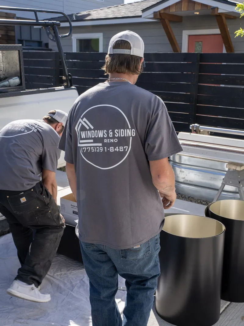 Two of our crew unloading window materials from a branded work truck